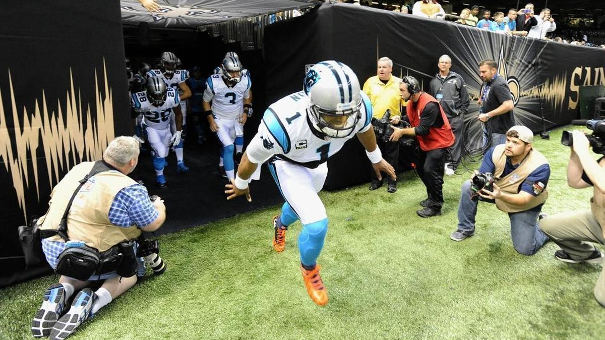 Carolina Panthers quarterback Cam Newton (1) runs out onto the field before his team takes on the New Orleans Saints at Mercedes-Benz Superdome on Sunday.