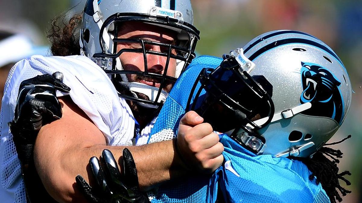 
Carolina Panthers center Brian Folkerts (64) battles defensive tackle Colin Cole (91) during practice on July 29, 2014 at Wofford College in Spartanburg, S.C.
