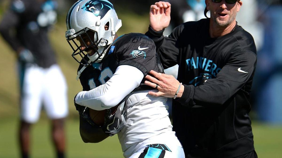 Carolina Panthers wide receiver Philly Brown, left, clutches the ball as wide receivers coach Ricky Proehl, right, pressures him during practice on Wednesday, October 26, 2016.