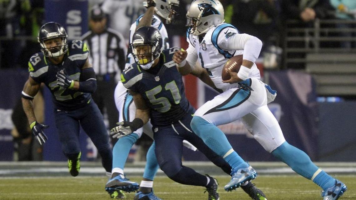 
Carolina Panthers' Cam Newton (1) heads upfield past Seattle Seahawks' Bruce Irvin (51) in the second half of their NFC Divisional game at CenturyLink Field on Saturday, January 10, 2015. Seattle won 31-17. 
