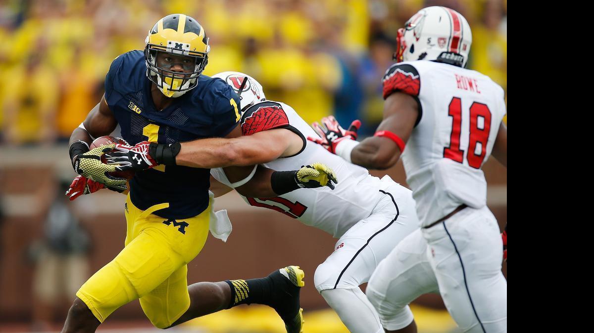 
Devin Funchess (1) of Michigan is a big wide receiver, but his 40-yard dash time at the NFL combine had some scouts wondering if he should play tight end in the NFL. 
