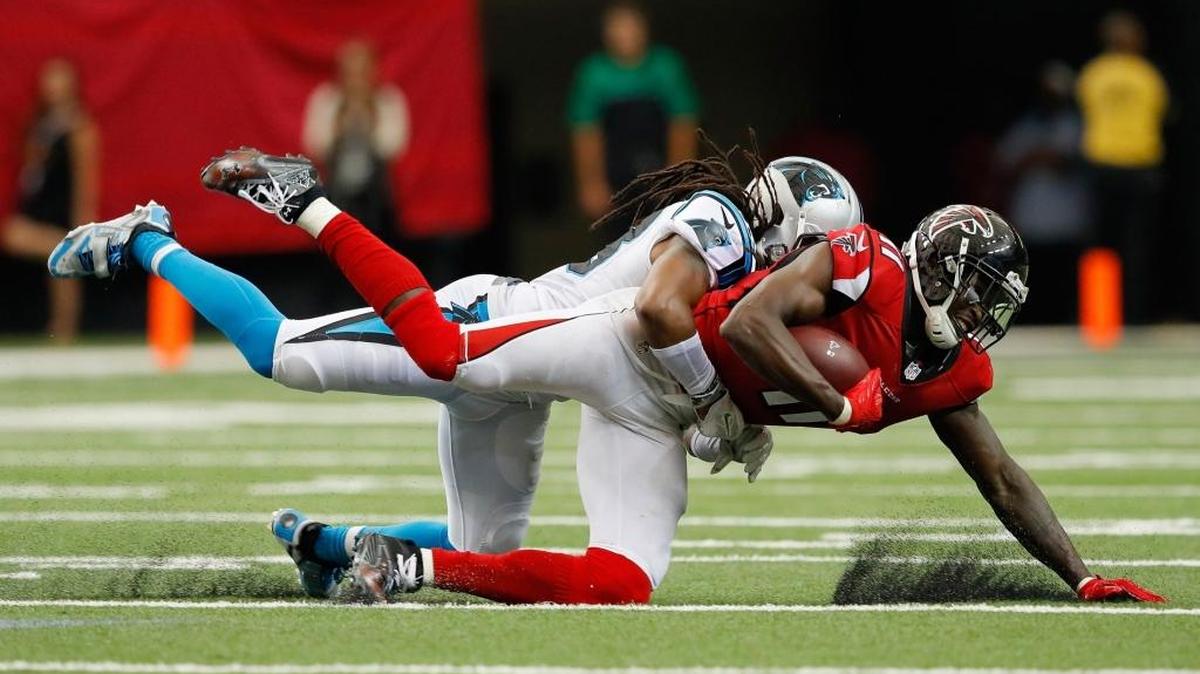 Julio Jones (11) of the Atlanta Falcons is tackled by Tre Boston (33) of the Carolina Panthers at Georgia Dome on Sunday.