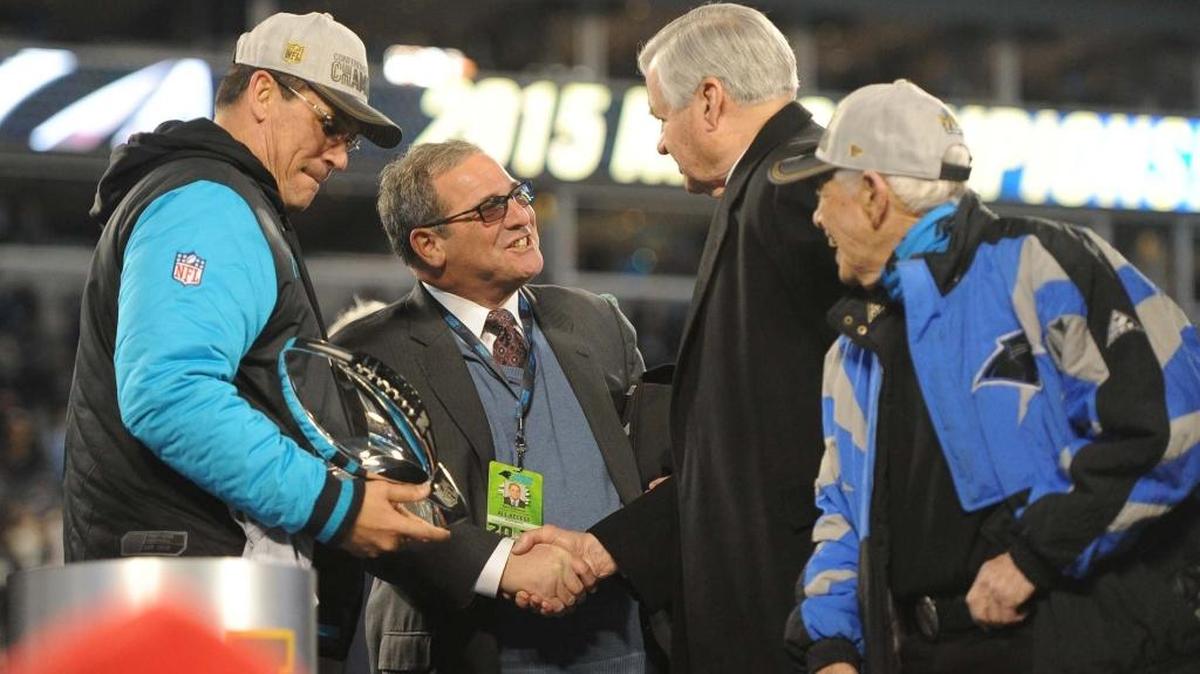 Panthers general manager Dave Gettleman (second from left) celebrates winning the NFC with coach Ron Rivera (left) and owner Jerry Richardson (center). Also pictured, former banking executive Hugh McColl.
