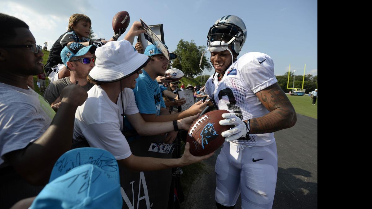 
Carolina Panthers wide receiver Kelvin Benjamin (13) signs autographs for fans after an afternoon practice during the 2014 training camp at Wofford College in Spartanburg, S.C.
