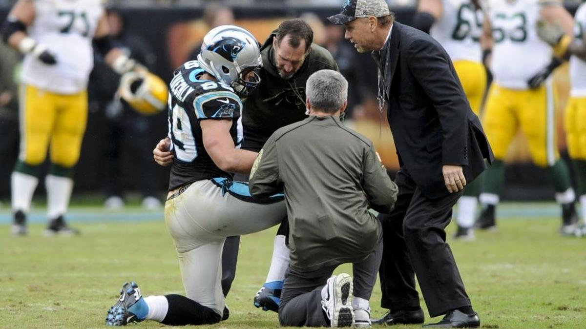 Carolina Panthers middle linebacker Luke Kuechly (59) is checked by medical staff during the second half against the Green Bay Packers on Sunday. An injured right ankle kept him out of Wednesday’s practice, as expected.