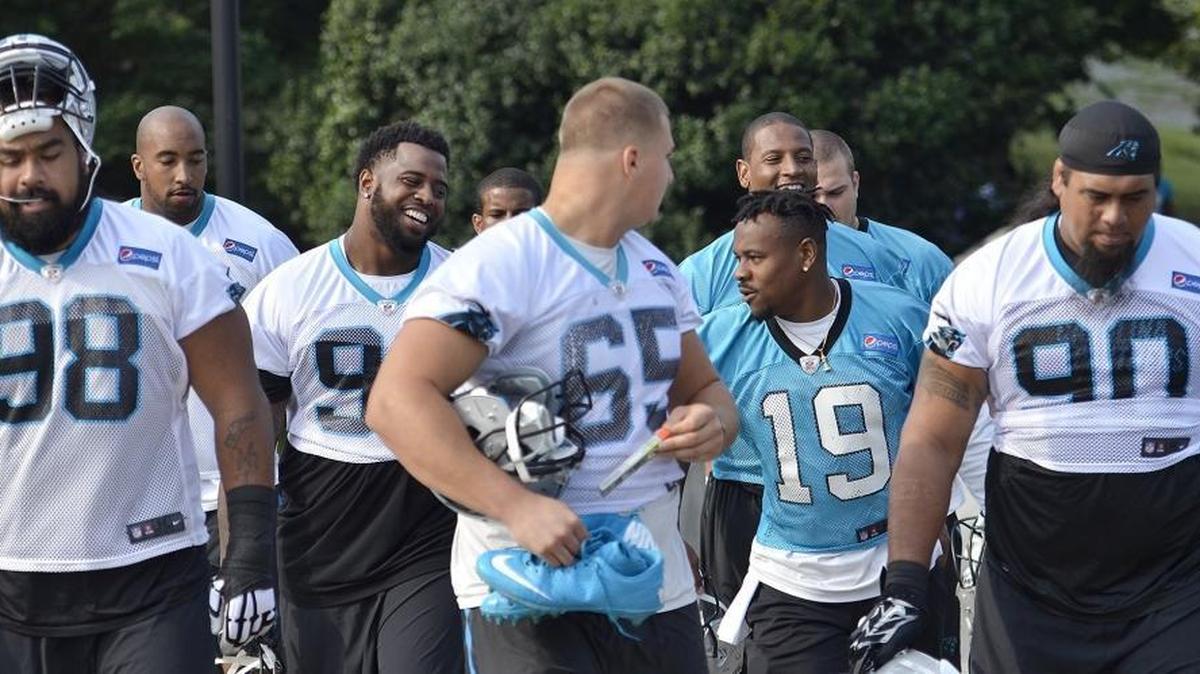 Kawann Short (third from left and teammate Ted Ginn Jr. (19) joke around on the way to the Panthers minicamp practice on Tuesday. Short had skipped more than a week of voluntary workouts with the team before Tuesday’s mandatory practice.