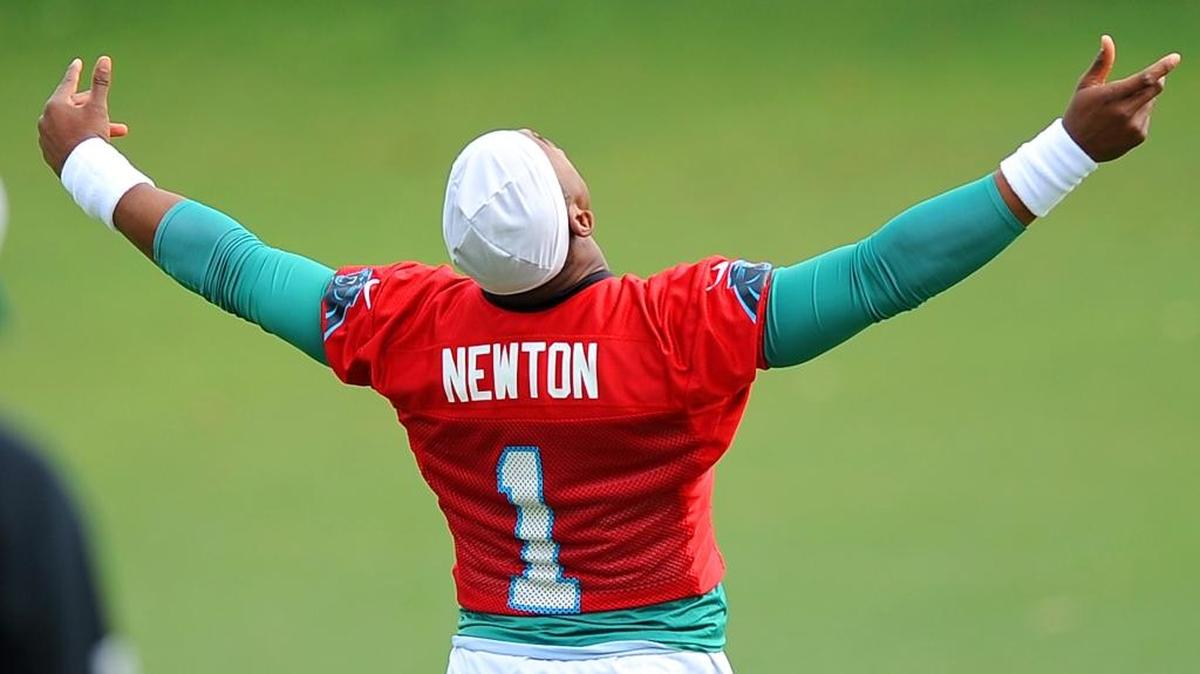 Carolina Panthers quarterback Cam Newton basks in the morning light during Thursday’s practice.