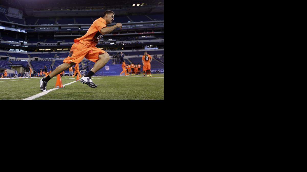 
Oregon quarterback Marcus Mariota runs a drill at the NFL football scouting combine in Indianapolis Saturday. Many analysts believe Mariota will be one of the first players taken in the 2015 draft. 
