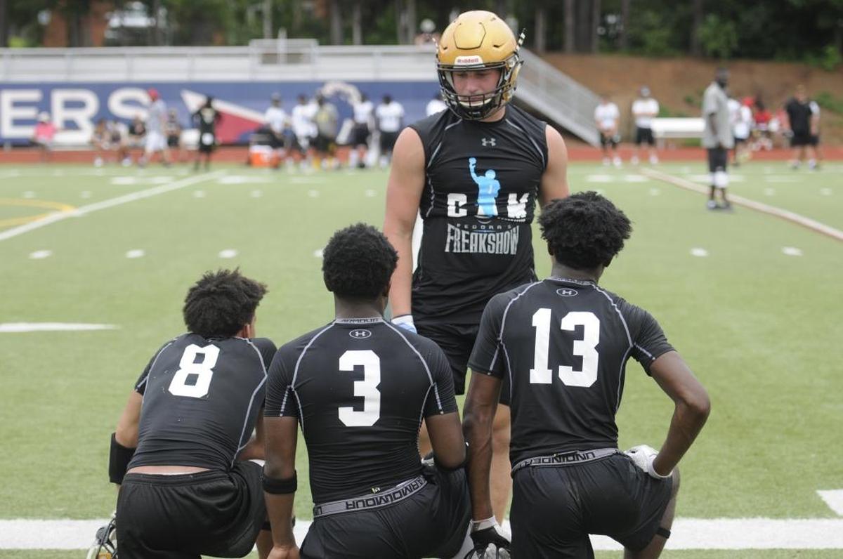 Dax Hollifield, a four-star linebacker at Shelby High School, speaks with teammates on the sideline during the Cam Newton Foundation's annual 7-on-7 football tournament on Saturday at Providence Day School.