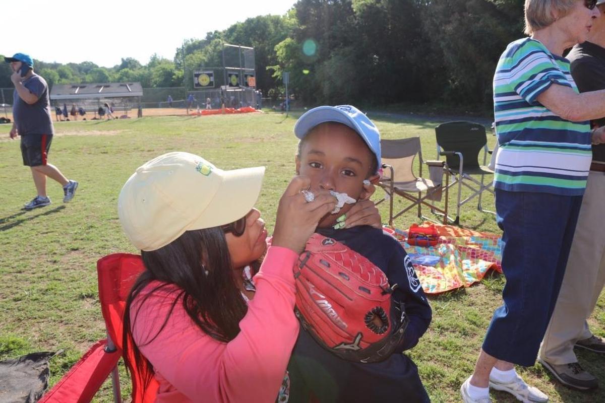 Charles Johnson’s son, Prince, gets a cleanup at the baseball fields.