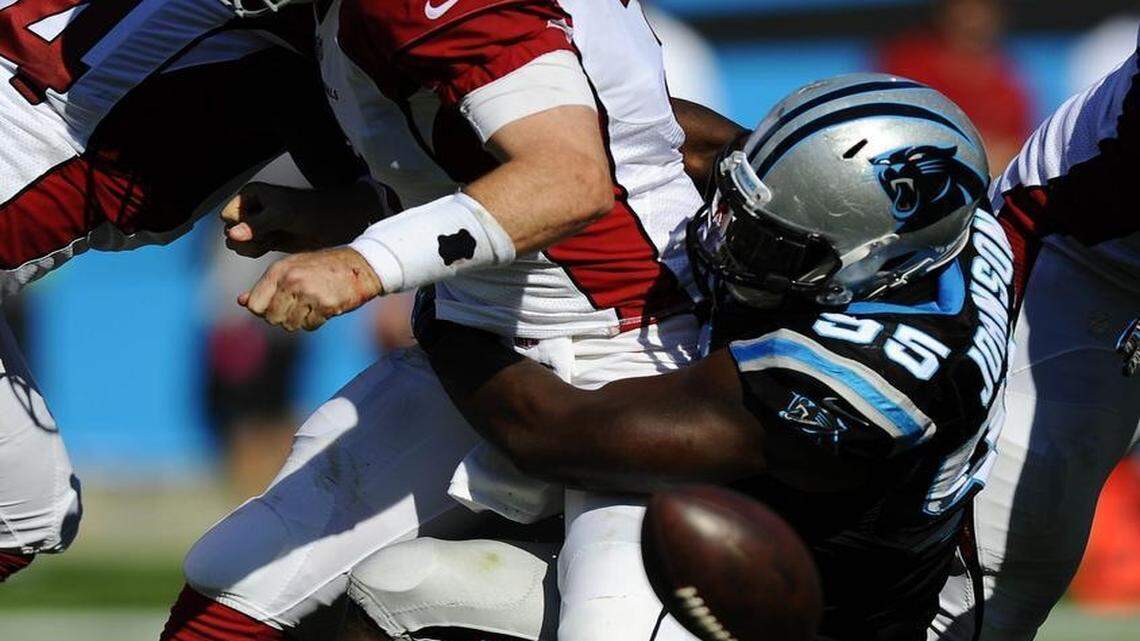Carolina Panthers defensive end Charles Johnson (95) sacks Arizona Cardinals quarterback Carson Palmer, causing him to fumble, during the second half of Sunday’s game. The Panthers won 30-20.