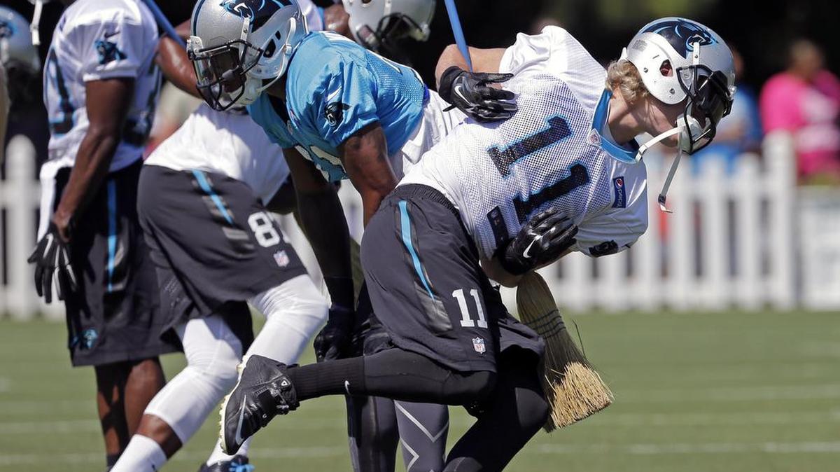 
Carolina Panthers' Brenton Bersin (11) uses a broom in a drill during the NFL football team's training camp in Spartanburg, S.C., Saturday, Aug. 1, 2015.
