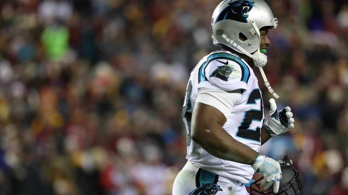 Carolina Panthers running back Jonathan Stewart (28) runs off of the field carrying his broken face mask in the second quarter against Washington, after an 8-yard run that helped set a physical tone.