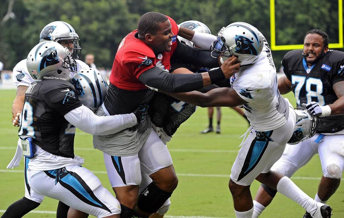 In 2015, Carolina Panthers teammates try to separate quarterback Cam Newton and cornerback Josh Norman during a skirmish at training camp in Spartanburg.
