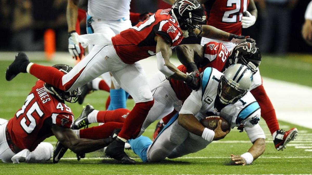 Carolina Panthers quarterback Cam Newton (1) is brought down by Atlanta Falcons strong safety Keanu Neal (22) during the first half of Sunday’s game in Atlanta.