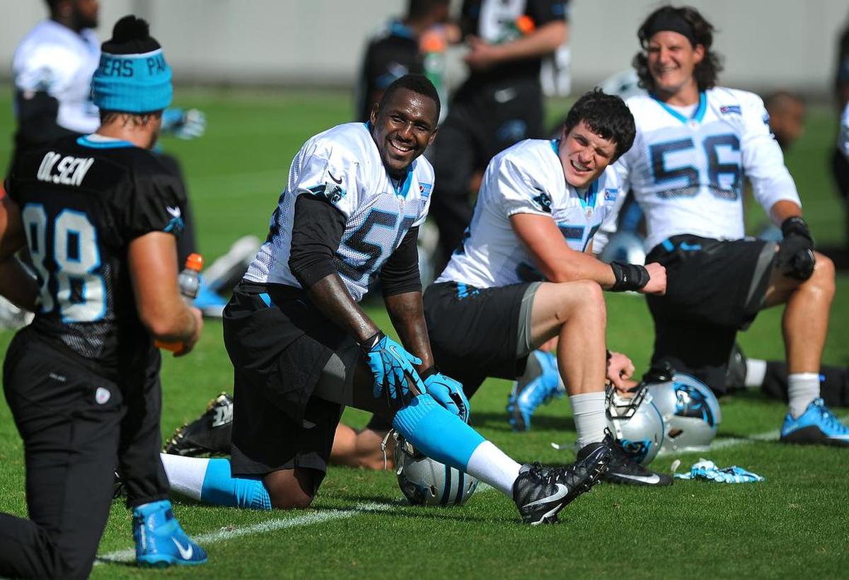 Carolina Panthers linebackers Thomas Davis, Luke Kuechly and A.J. Klein watch quarterback Derek Anderson do an impromptu dance while the team stretches prior to practice on Thursday, November 5, 2015.
