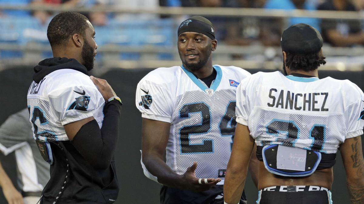 In this photo taken Aug. 5, 2016,  Carolina Panthers' James Bradberry, center, talks with Zack Sanchez, right, and Daryl Worley, left, at their annual Fan Fest practice during NFL training camp in Charlotte, N.C. As the Panthers wrap up training camp at Wofford College, Panthers defensive coordinator Sean McDermott said he likes what he sees so far from the team's three rookie cornerbacks who are looking to replace All-Pro Josh Norman. (AP Photo/Chuck Burton)