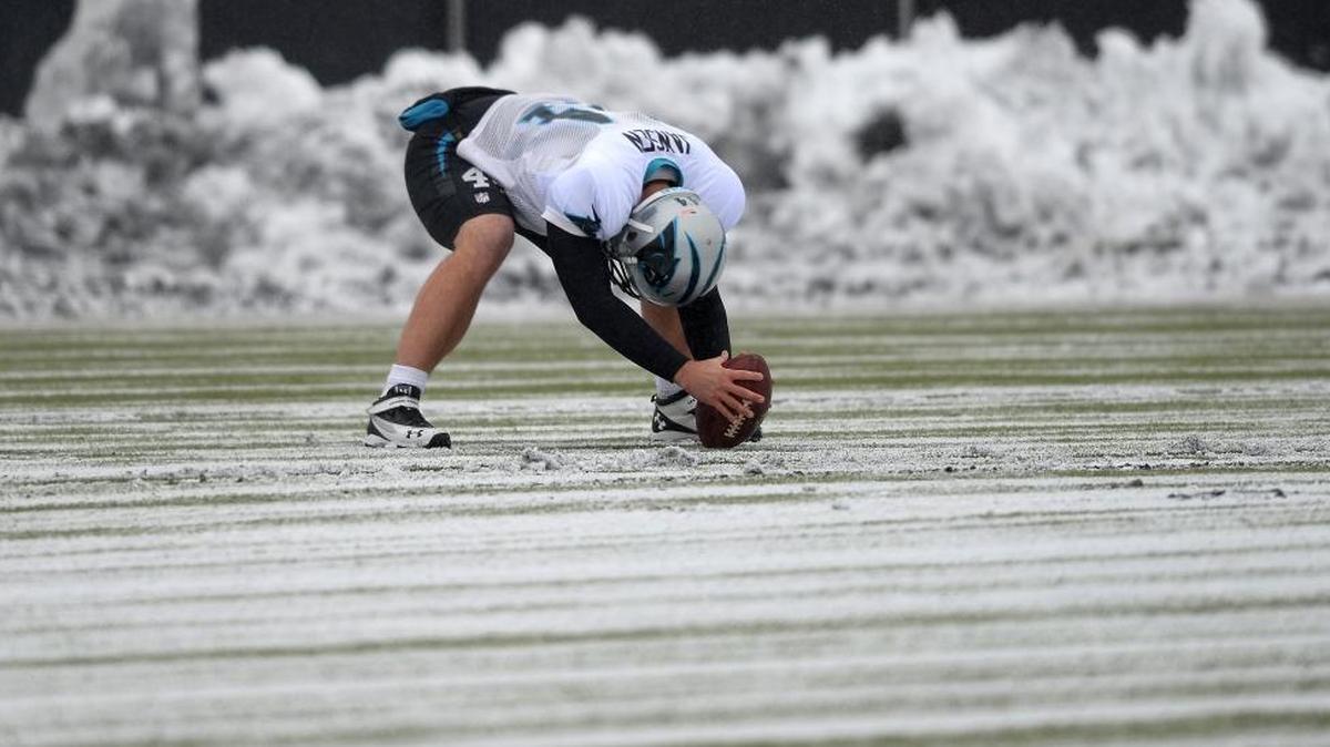 Carolina Panthers long snapper J.J. Jansen prepares to snap the ball to punter Brad Nortman during practice on Jan. 22.