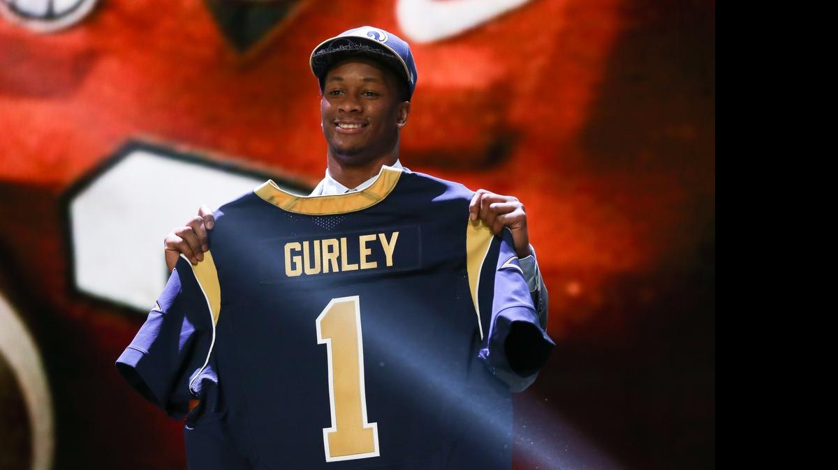 
Tarboro native Todd Gurley of the Georgia Bulldogs holds up a jersey after being picked No. 10 overall by the St. Louis Rams during the first round of the 2015 NFL Draft.
