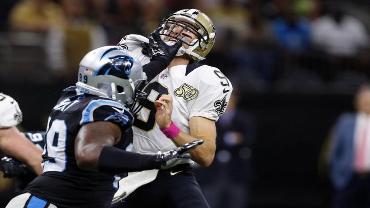 Carolina Panthers defensive tackle Kawann Short (99) shoves New Orleans Saints quarterback Drew Brees (9) down by the face after Brees released a touchdown throw in the second half of Sunday’s game in New Orleans. Short was called for a personal foul on the play.