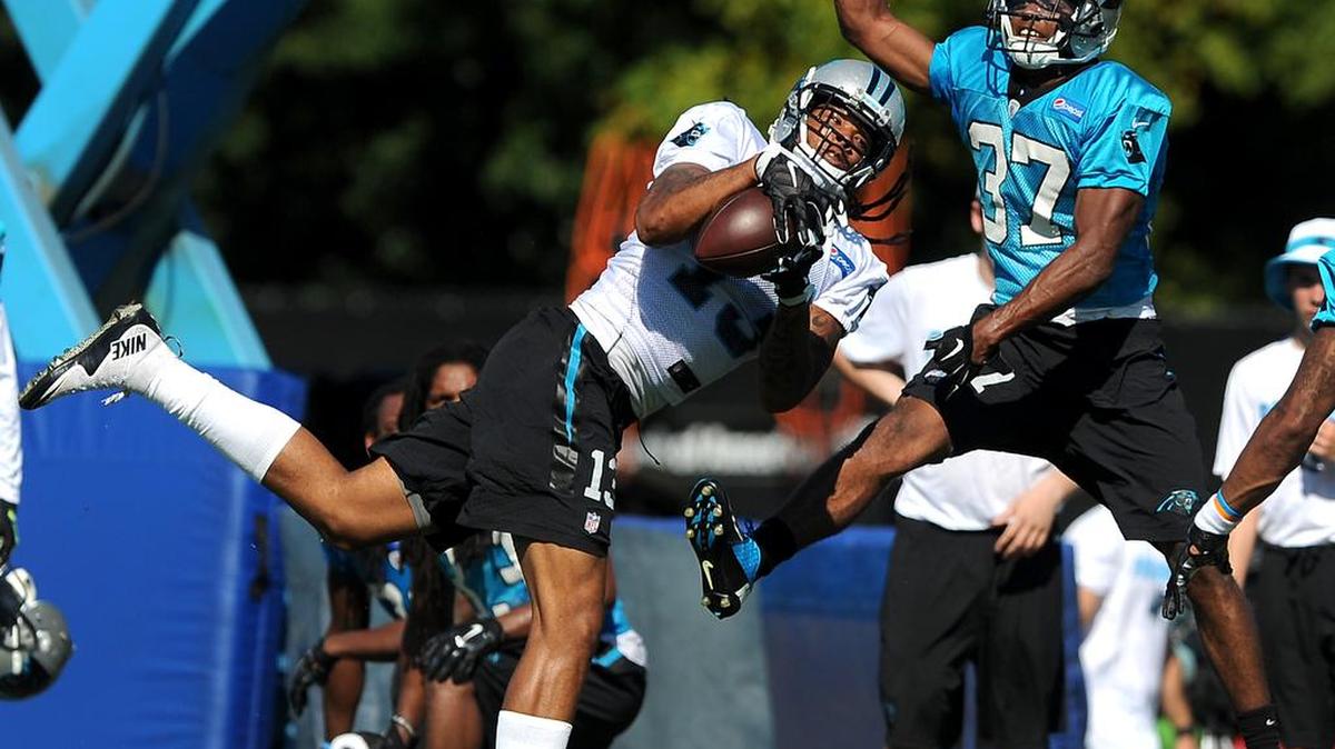 
Carolina Panthers wide receiver Kelvin Benjamin, left, makes an acrobatic pass reception as cornerback Carrington Byndom, right, applies defensive pressure during practice at Wofford College in Spartanburg, S.C., on Saturday, Aug. 1, 2015.
