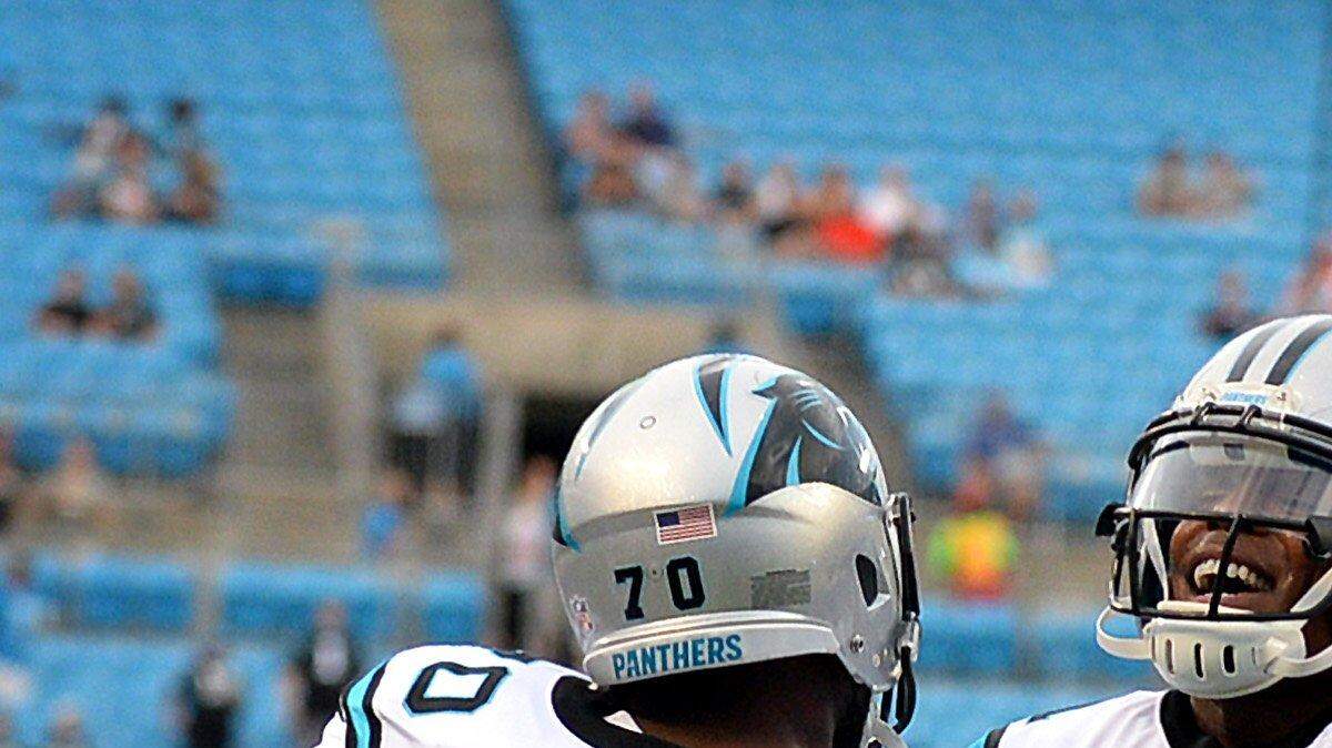 Carolina Panthers quarterback Cam Newton, right, welcomes guard Trai Turner, left, to the field at Bank of America Stadium during a pre-game warmup on Friday, Aug. 26, 2016. The Panthers host the New England Patriots in preseason NFL action.