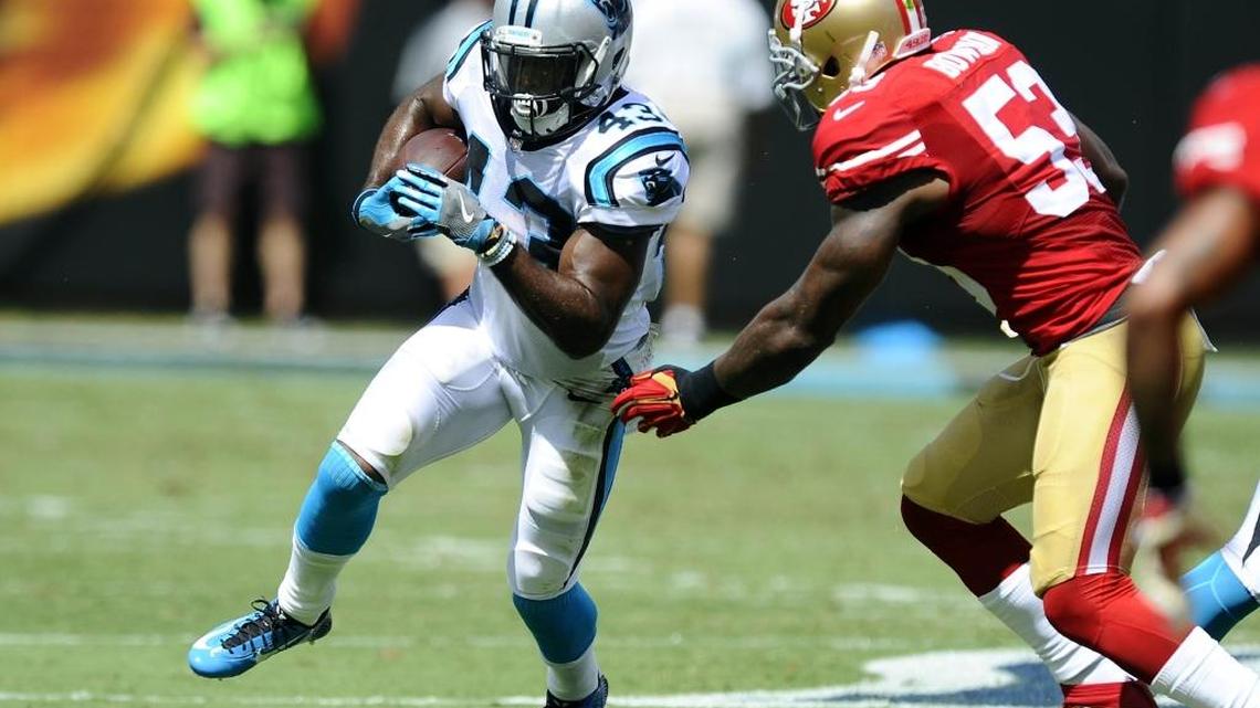 Carolina Panthers running back Fozzy Whittaker (43) heads upfield against San Francisco 49ers inside linebacker NaVorro Bowman (53) in the first half at Bank of America Stadium on Sunday. Whittaker finished with 100 yards on 16 carries as the Panthers won 46-27.