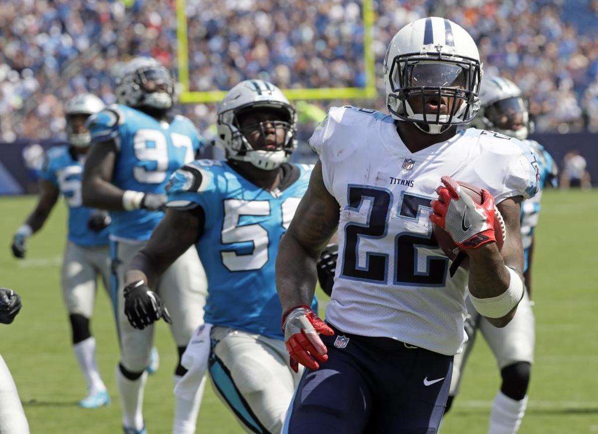 Tennessee Titans running back Derrick Henry (22) scores a touchdown on a 17-yard run ahead of Carolina Panthers defenders in the first half of an NFL football preseason game, Saturday, Aug. 19, 2017, in Nashville, Tenn.