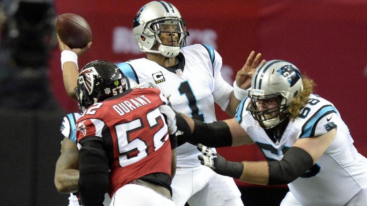 Carolina Panthers quarterback Cam Newton (1) throws downfield as Atlanta Falcons' Justin Durant (52) pressures in the first half at the Georgia Dome on Sunday. The Falcons won 20-13, spoiling the Panthers bid for an undefeated season.