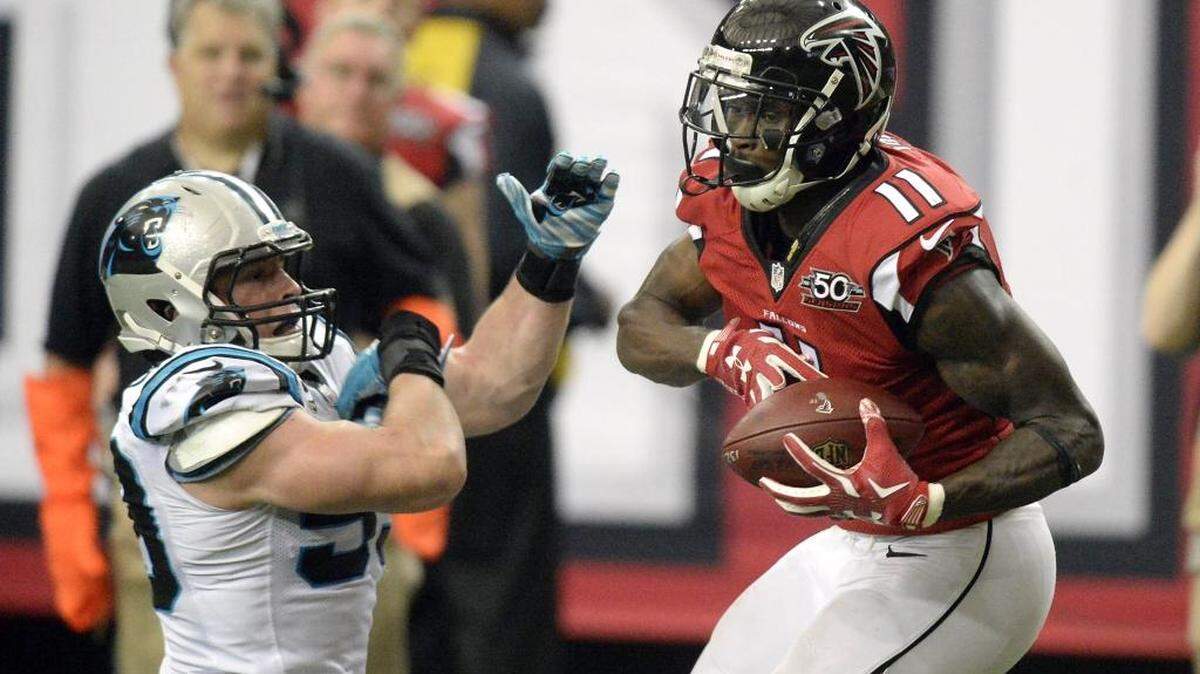 Atlanta Falcons wide receiver Julio Jones (11) completes a 70-yard reception for a touchdown over Carolina Panthers linebacker Luke Kuechly (59) in the third quarter at the Georgia Dome on Sunday.