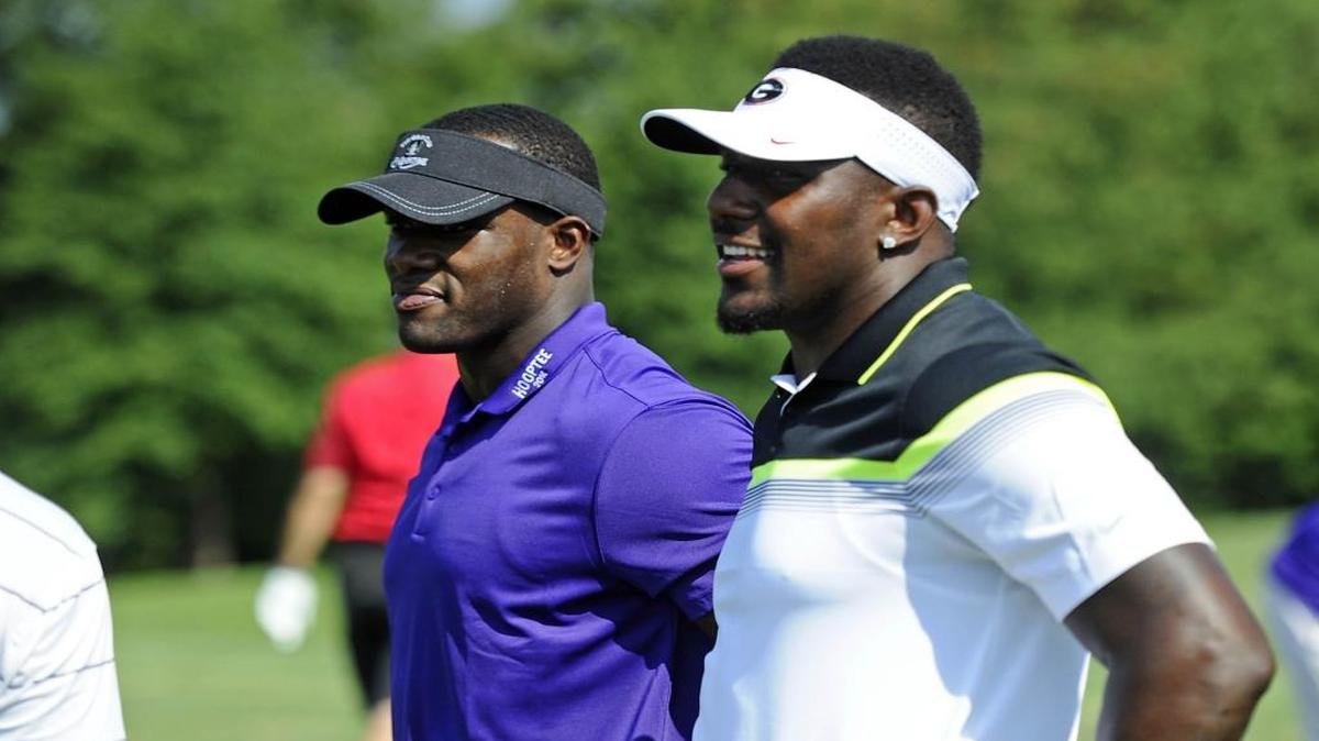 Former Carolina Panthers linebacker Jon Beason, left, and current Carolina Panthers linebacker Thomas Davis talk at the start of HoopTee Celebrity Golf Classic at the Golf Club at Ballantyne on Thursday.