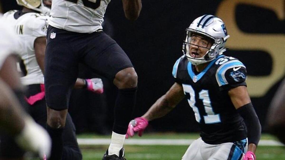 Carolina Panthers cornerback Zack Sanchez, right, looks on as Saints wide receiver Michael Thomas catches a pass from quarterback Drew Brees during the third quarter Sunday in New Orleans. The Saints defeated the Panthers 41-38.