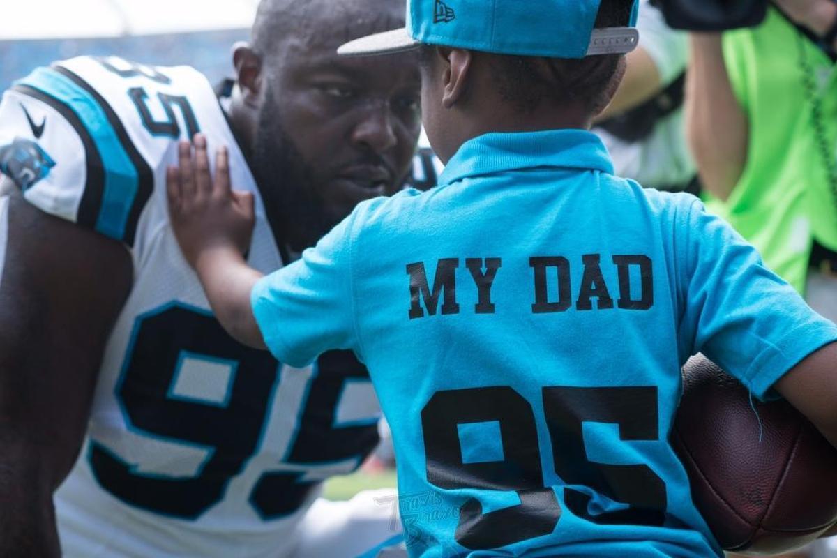 Carolina defensive end Charles Johnson visits with his son, Prince, before a Panthers game.
