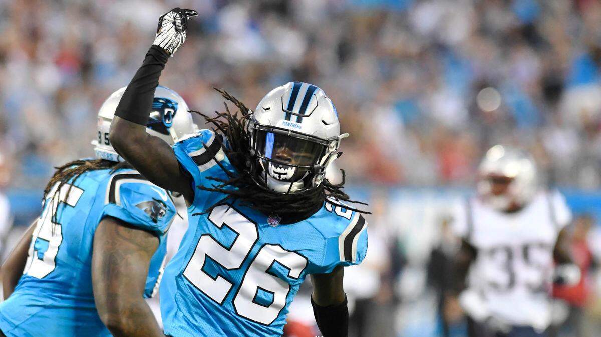 Carolina Panthers cornerback Donte Jackson (26) celebrates his tackle on New England Patriots running back James White (28) in the first half at Bank of America Stadium in Charlotte, N.C., on Friday, Aug. 24, 2018. (David T. Foster III/Charlotte Observer/TNS)