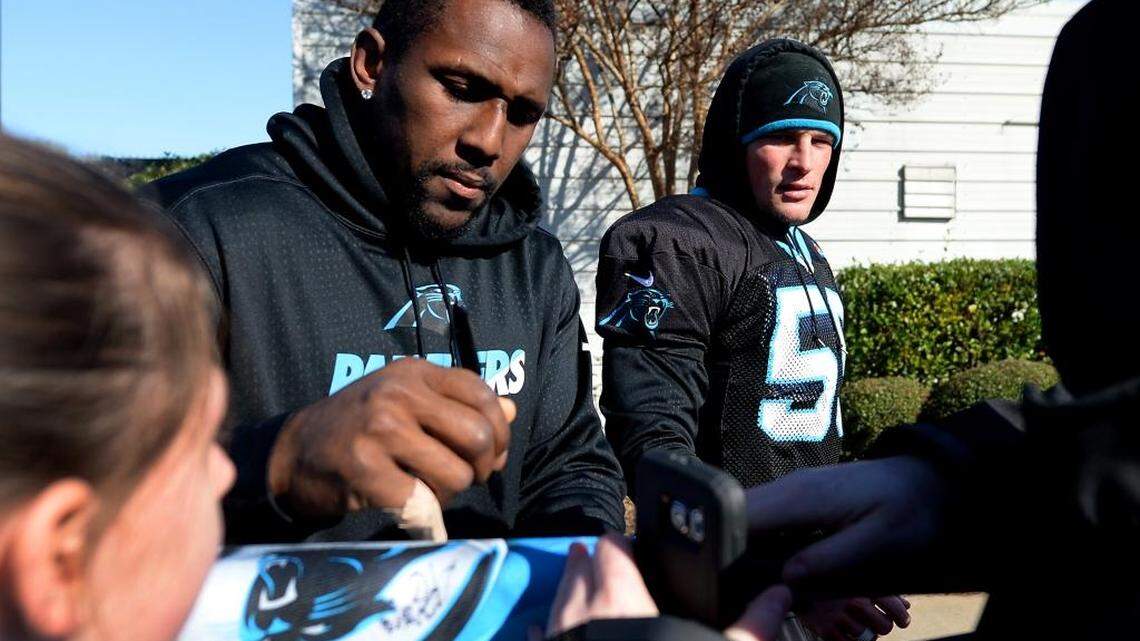 Carolina Panthers linebacker Thomas Davis, left, stops to sign autographs for fans following practice on Wednesday. Davis learned Wednesday that he has won the NFL’s Bart Starr Award, given to a player who exemplifies character and leadership.