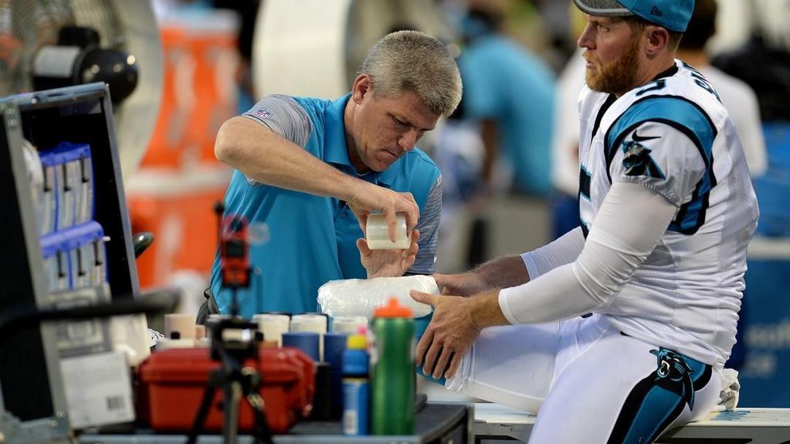 Carolina Panthers punter Mike Scifres has his right knee wrapped in an ice pack by a trainer after a punt against the New England Patriots at Bank of America Stadium on Friday.