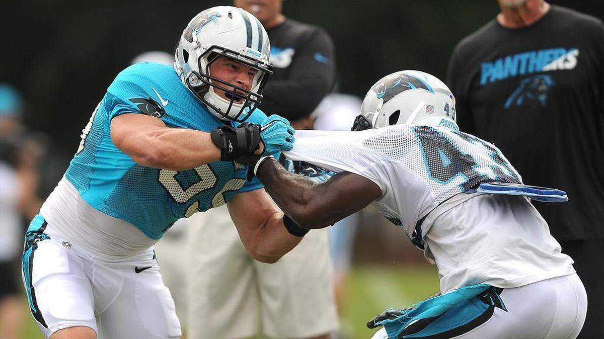 
Carolina Panthers linebacker Luke Kuechly, left, and running back Fozzy Whittaker, right, battle one another during practice on Wednesday.
