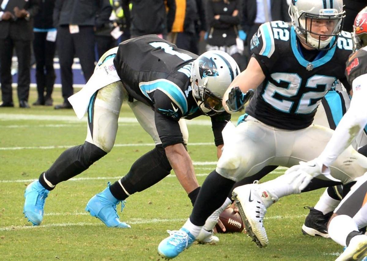 Carolina Panthers quarterback Cam Newton, left, recovers the ball off the ground after dropping it on a snap near the goal line in the final seconds of the fourth quarter Sunday. Newton recovered and scored on a two-yard touchdown run -- the deciding points in Carolina’s 22-19 win over Tampa Bay.