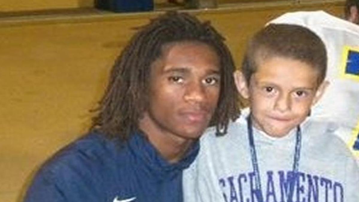 Shaq Thompson (left) then a Grant Pacer, hugs Milo Graniel after a game.
