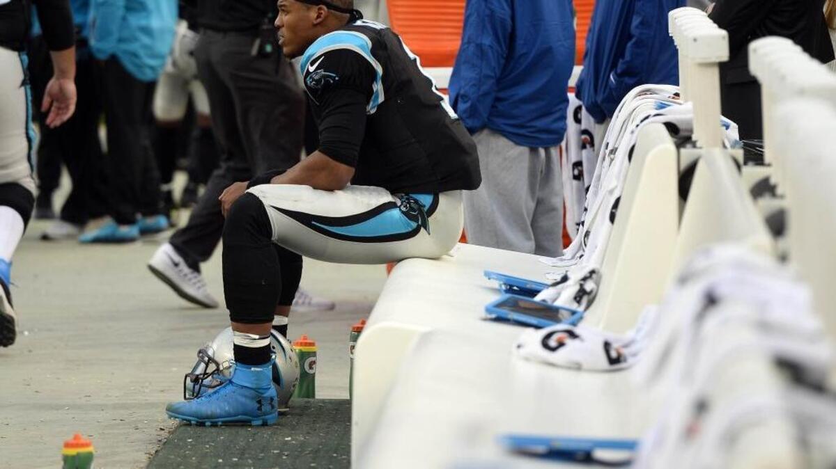 Carolina Panthers quarterback Cam Newton watches from the bench late in the game against the Atlanta Falcons at Bank of America Stadium on Saturday. The Falcons won 33-16 and the Panthers dropped to 6-9.