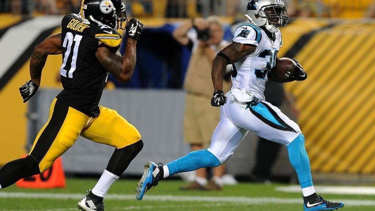 
Carolina Panthers running back Jordan Todman, right, breaks toward the sideline as Pittsburgh Steelers safety Robert Golden, right, gives chase during second quarter action on Thursday at Heinz Field in Pittsburgh. Todman scored a touchdown on the play.
