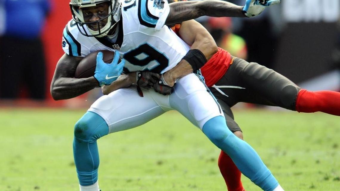 Carolina Panthers wide receiver Ted Ginn Jr. tries to shake free of Tampa Bay cornerback Brent Grimes on Sunday in Tampa, Florida. The Buccaneers won 17-16.