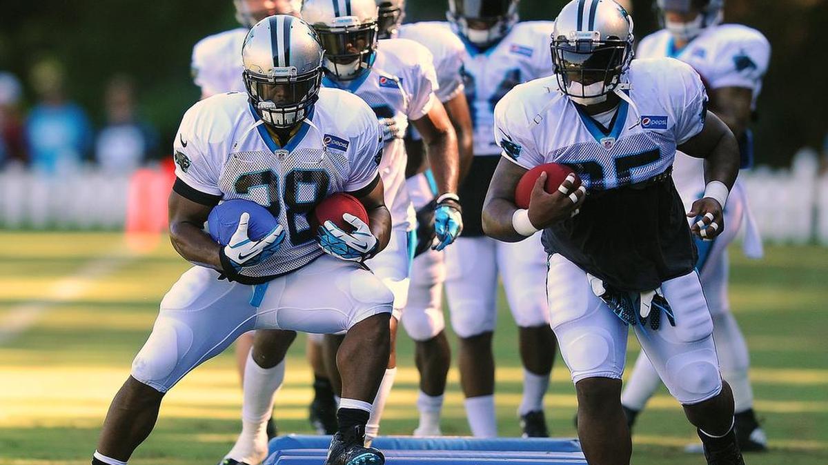 
Carolina Panthers running back Jonathan Stewart, left, and fullback Mike Tolbert cut around pads on Sunday.


