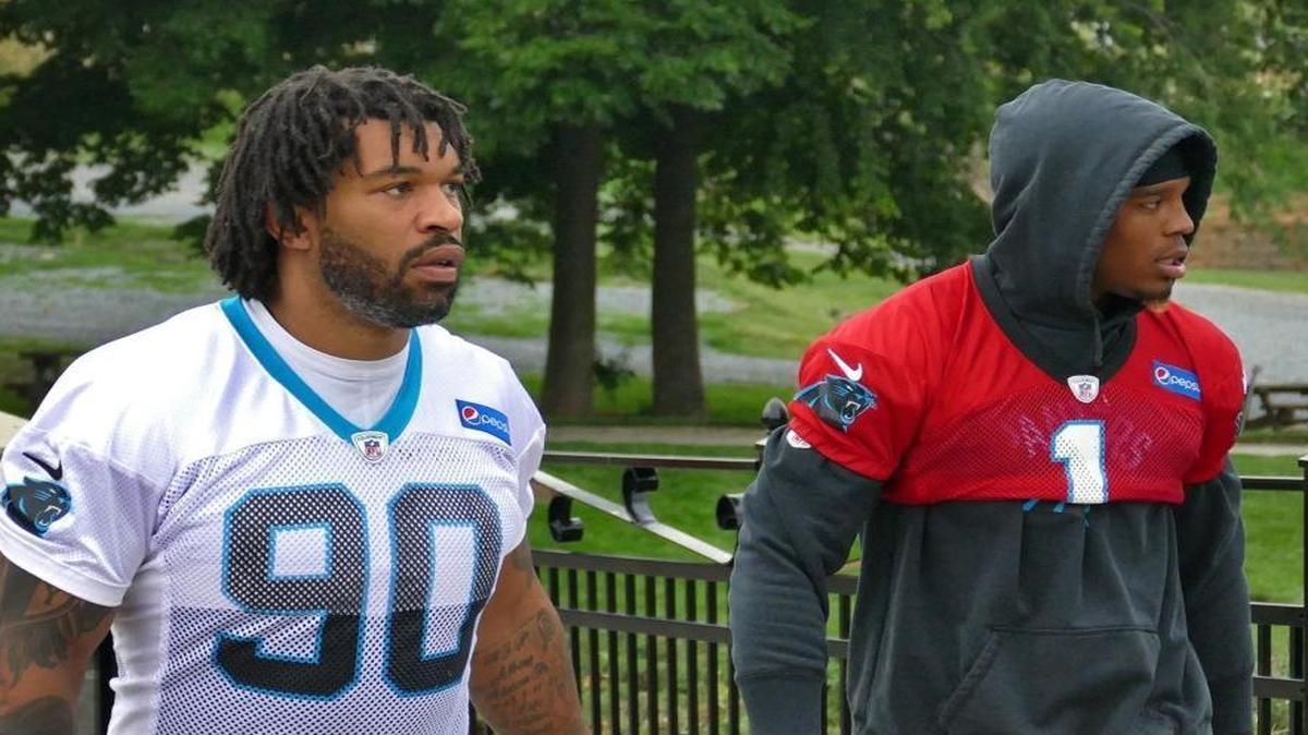 Defensive end Julius Peppers and quarterback Cam Newton walk to practice at the Carolina Panthers minicamp, Tuesday, June 13, 2017.