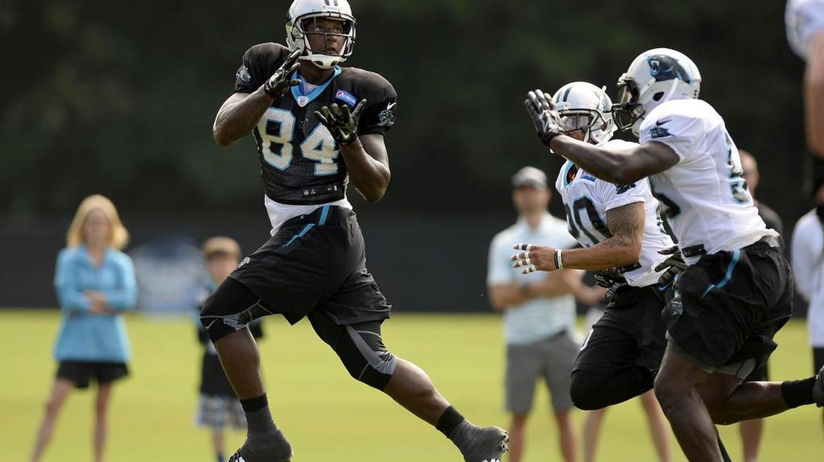 
Carolina Panthers' Ed Dickson (84) makes a reception past Thomas Davis (58) and Kurt Coleman (20) during morning practice at training camp.
