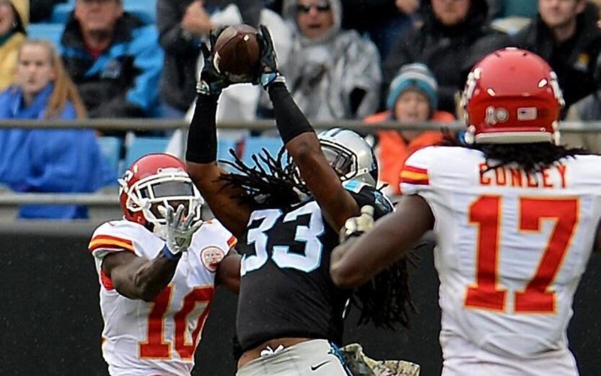 Carolina Panthers safety Tre Boston, center, intercepts a pass by Kansas City Chiefs quarterback Alex Smith meant for wide receiver Tyreek Hill, left, during Sunday’s game.. The Chiefs defeated the Panthers 20-17.