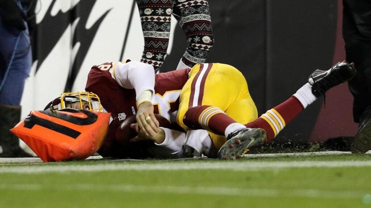 LANDOVER, MD - DECEMBER 19: Quarterback Kirk Cousins #8 of the Washington Redskins is pushed out of bounds in the fourth quarter against the Carolina Panthers at FedExField on December 19, 2016 in Landover, Maryland. (Photo by Patrick Smith/Getty Images)