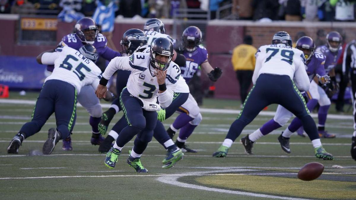Russell Wilson chases an errant snap during the fourth quarter of the Seahawks wild-card game against the Vikings last Sunday. He was able to recover the ball, scramble to avoid defenders, and threw it to Tyler Lockett for a 35-yard gain to the Vikings 4-yard line.
