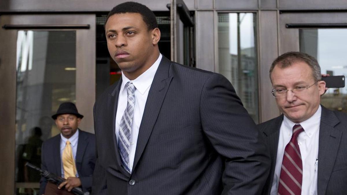 
Former Carolina Panthers player Greg Hardy, center, leaves the Mecklenburg County Courthouse after his domestic violence charges were dismissed in Charlotte on Feb. 9, 2015.
