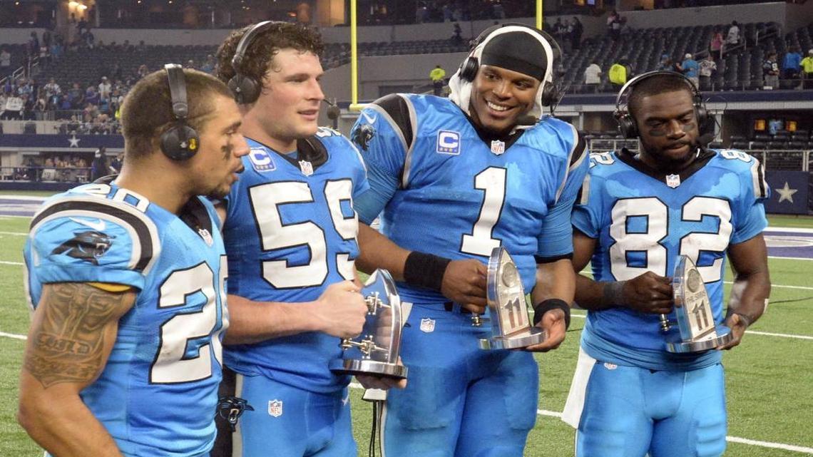 Carolina Panthers Kurt Coleman (20), Luke Kuechly (59), Cam Newton (1), and Jerricho Cotchery (82) joke around after a victory over the Dallas Cowboys on Thanksgiving Day.